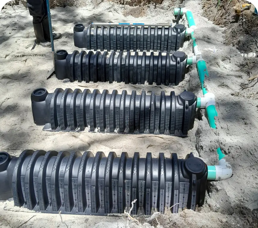 Black corrugated leach-field chambers laid in sand trench