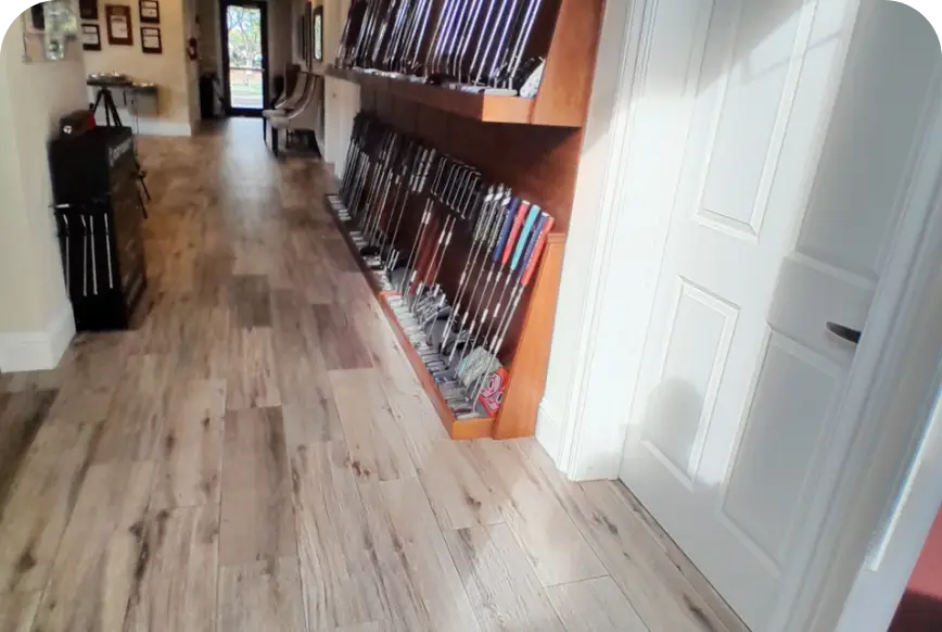 Wood-floored hallway with golf club fitting racks along the wall