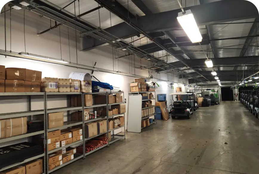 Parts shelving and storage aisle inside golf cart maintenance building