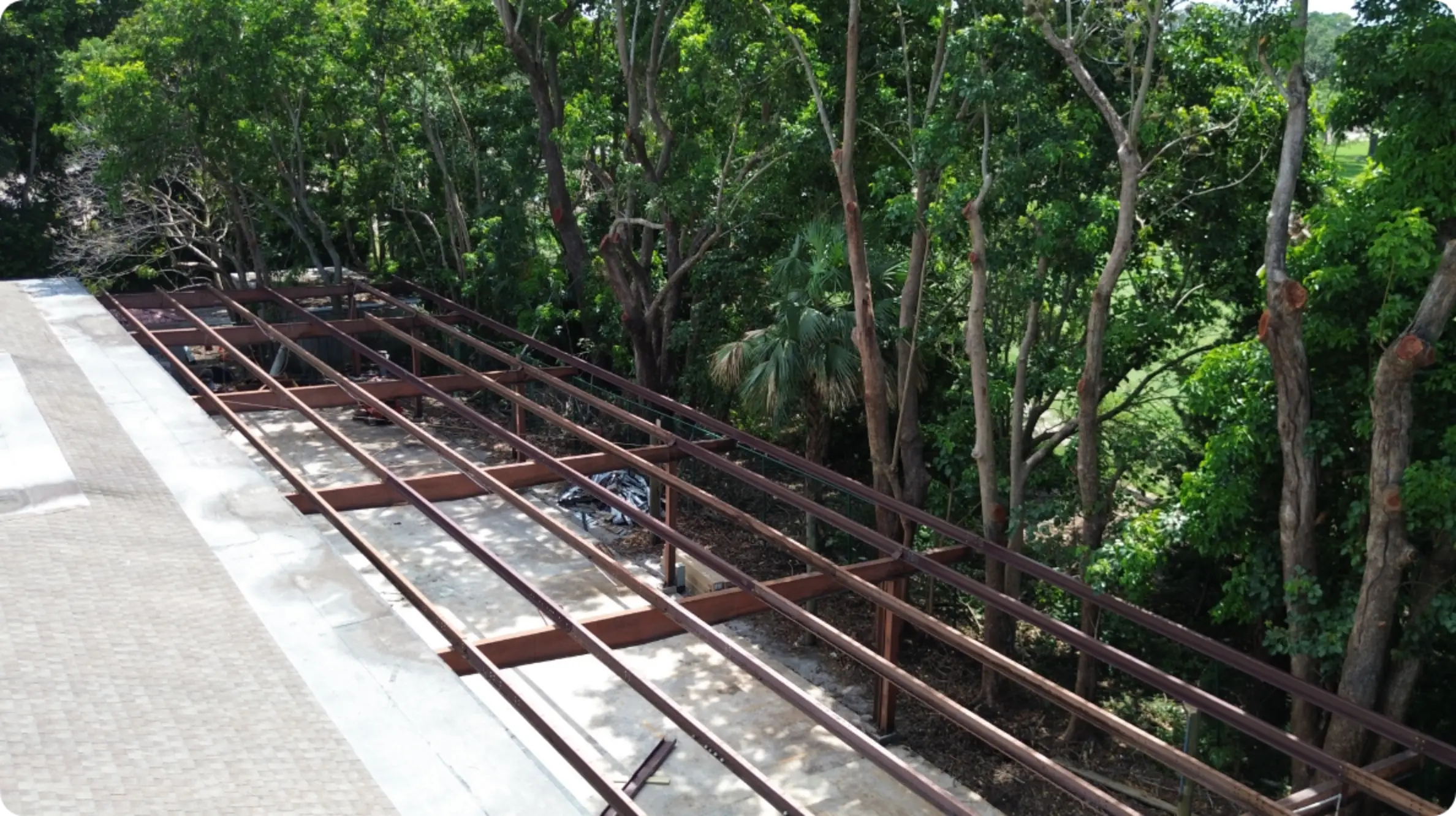 East Point Country Club maintenance facility steel purlin roof framing along treeline