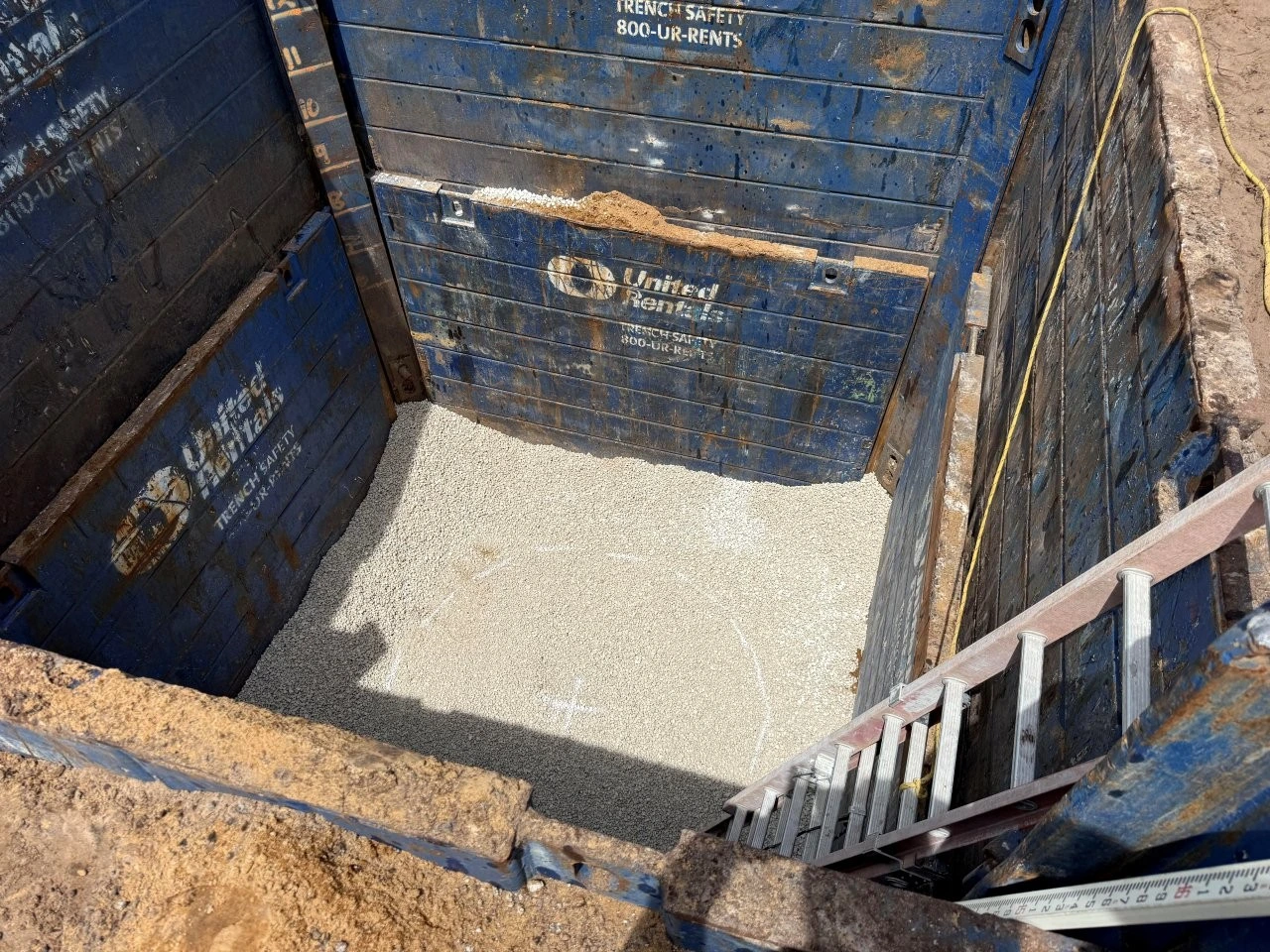 Gravel-filled United Rentals trench box in pump station excavation