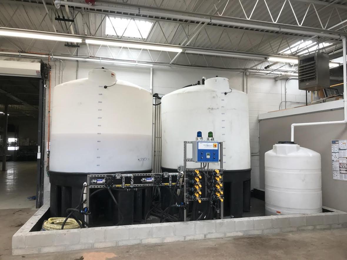 Large chemical storage tanks with injection manifold inside building