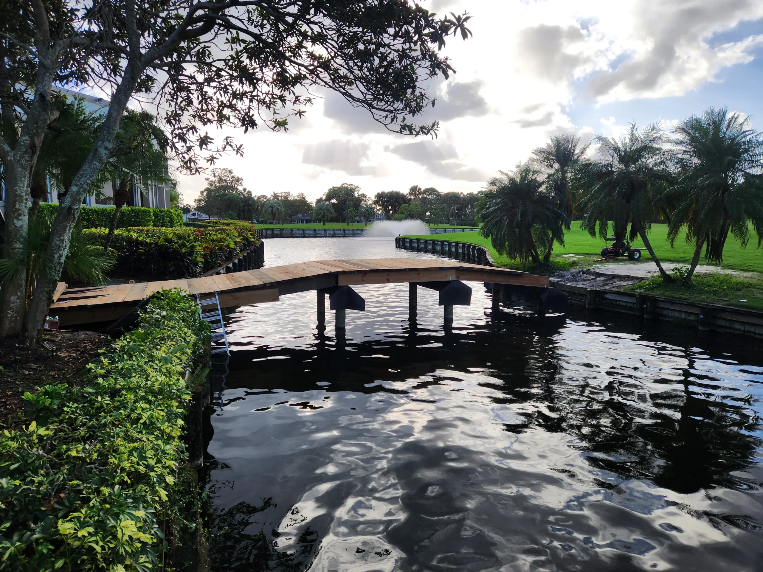 East Point new wooden footbridge over pond with fountain on golf course