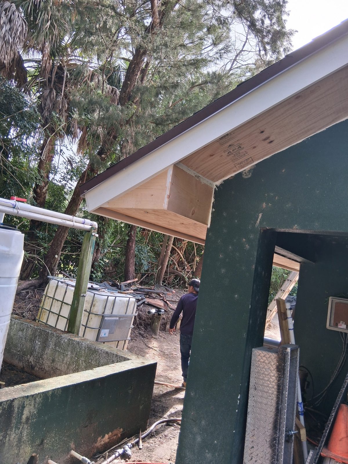 Renovated Old Marsh pump house showing the new soffit and fascia at the eave and the new diamond-plate access hatch on the building