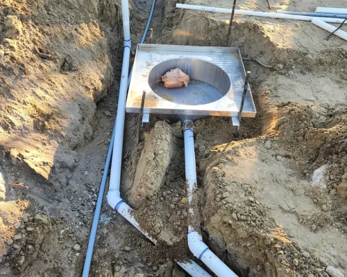 Sub-surface drainage plumbing and sump basin trenched in before the wash pad slab is poured