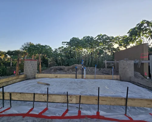 Reinforced wash pad base with rebar dowels, vapor barrier, and formwork before pouring