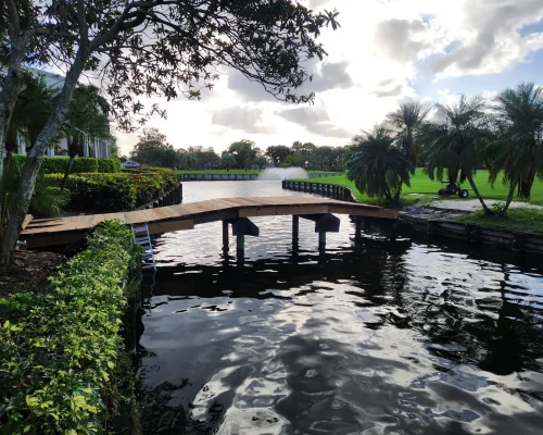 East Point new wooden footbridge over pond with fountain on golf course