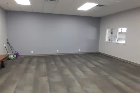 Empty office room with gray walls and interior windows