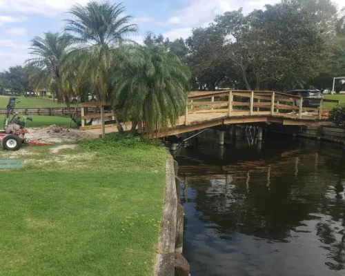 East Point completed arched wood footbridge over canal with golf cart