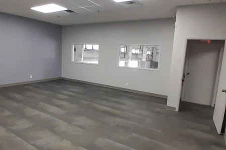 Renovated office interior with drop ceiling and vinyl flooring