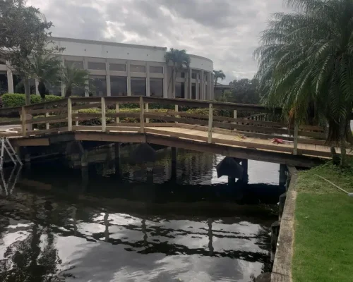 East Point wood footbridge over canal beside clubhouse building