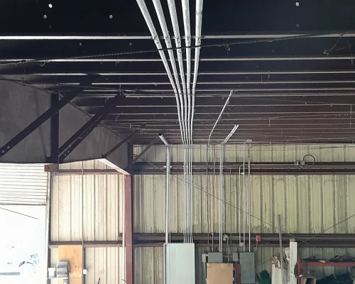 Wired electrical panel mounted inside metal maintenance building