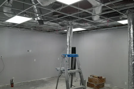 Suspended ceiling grid and ductwork installation over office