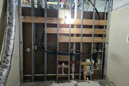 Metal-stud wall framing with plumbing and electrical rough-in
