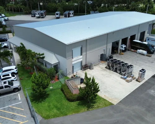 Aerial view of the completed Thermo King facility showing the extended footprint, new roof, and covered wash bay.