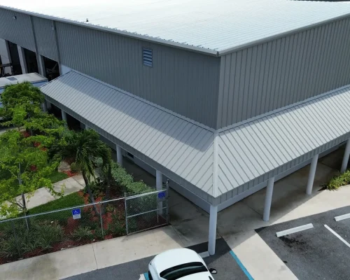 Corner view of the Thermo King building after reroofing and residing, showing clean new metal siding and a fresh roofline.